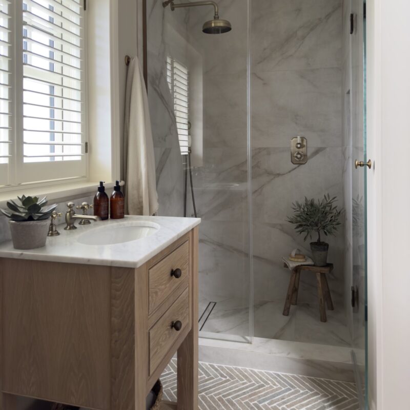 LAPICIDA Bordeaux Argento Herringbone tiles for bathroom floor and Antique Marble Calacatta Oro for shower walls by Rachael Somerville