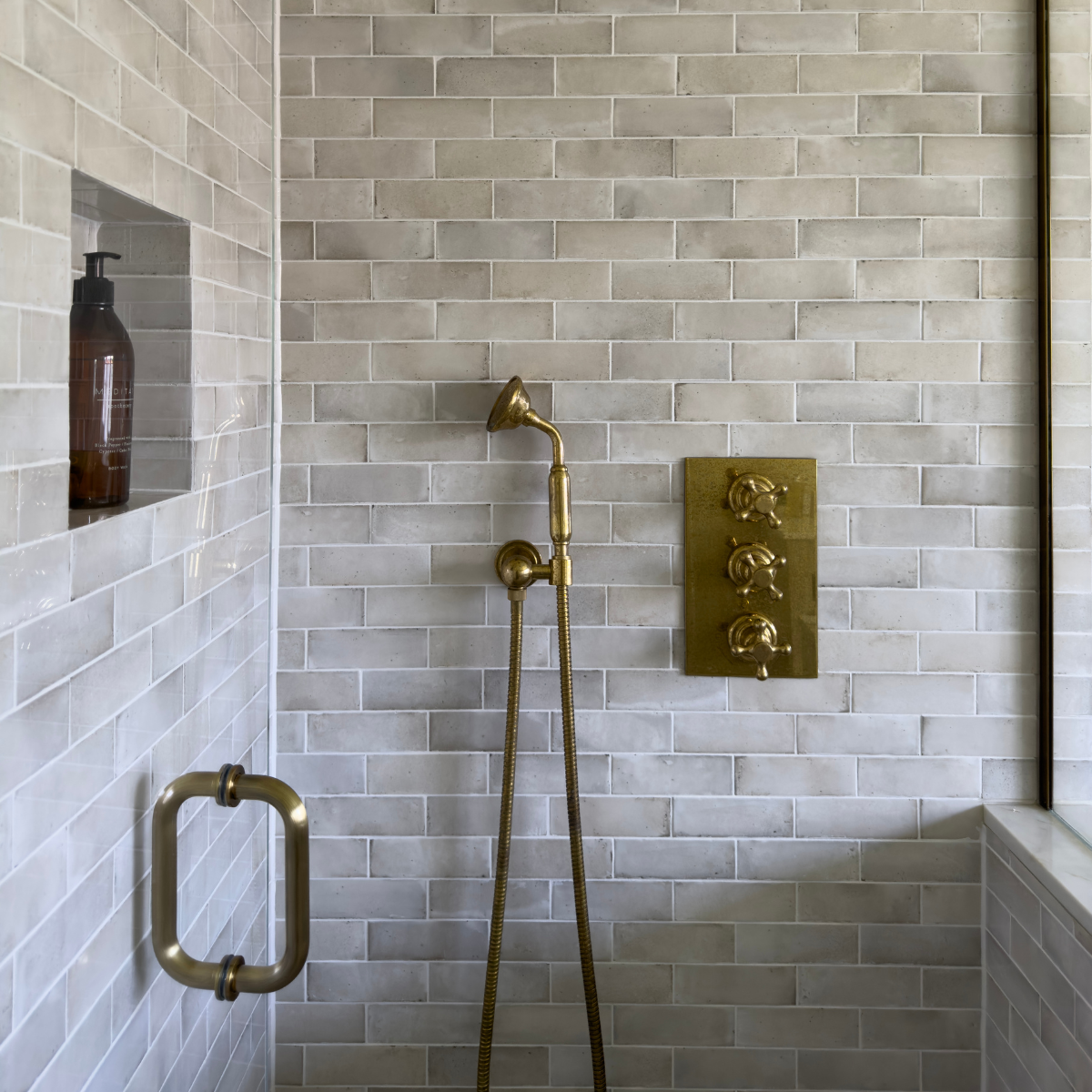 Lapicida Qualis Rice wall tiles in brick pattern inside bathrooms by Rachael Somerville Interiors